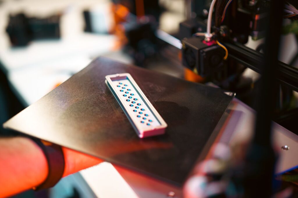 Mastering the First Impression: Your intriguing post title goes here Close-up of a 3D printed part on an industrial printer in a workshop setting.